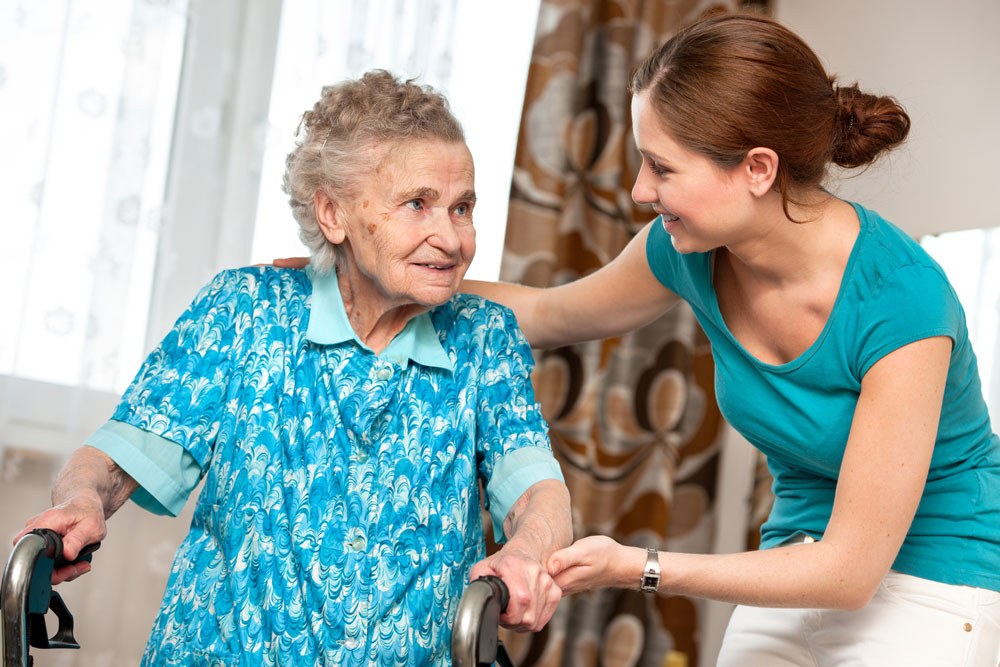 aide helping elderly woman