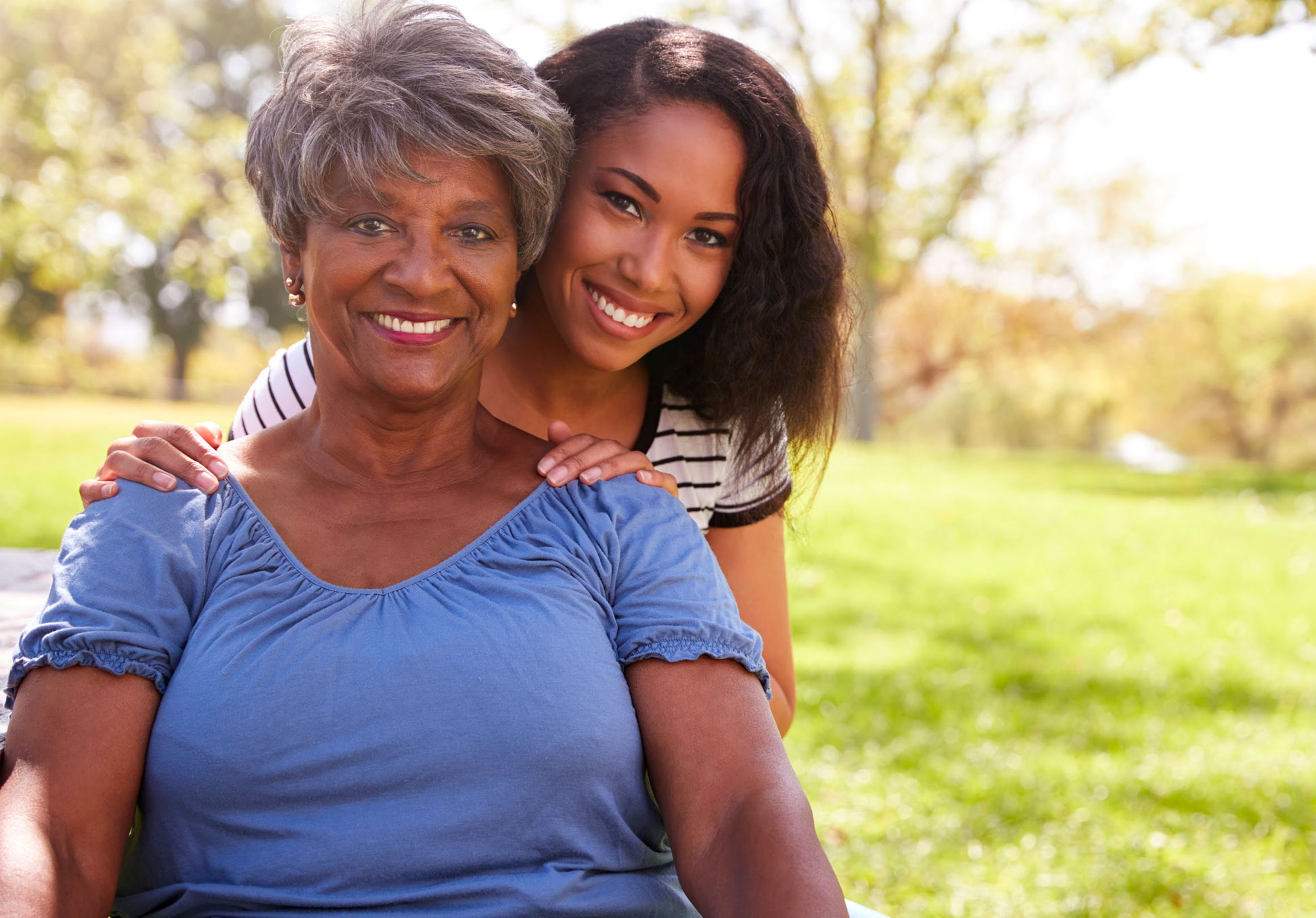 happy senior woman with caregiver daughter
