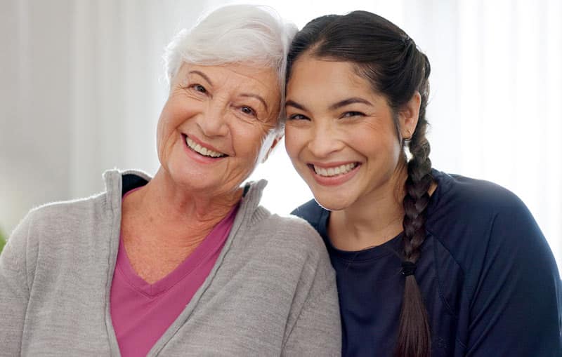 happy daughter caregiver with elderly mother