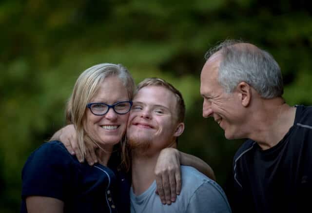 boy with down syndrome with parents