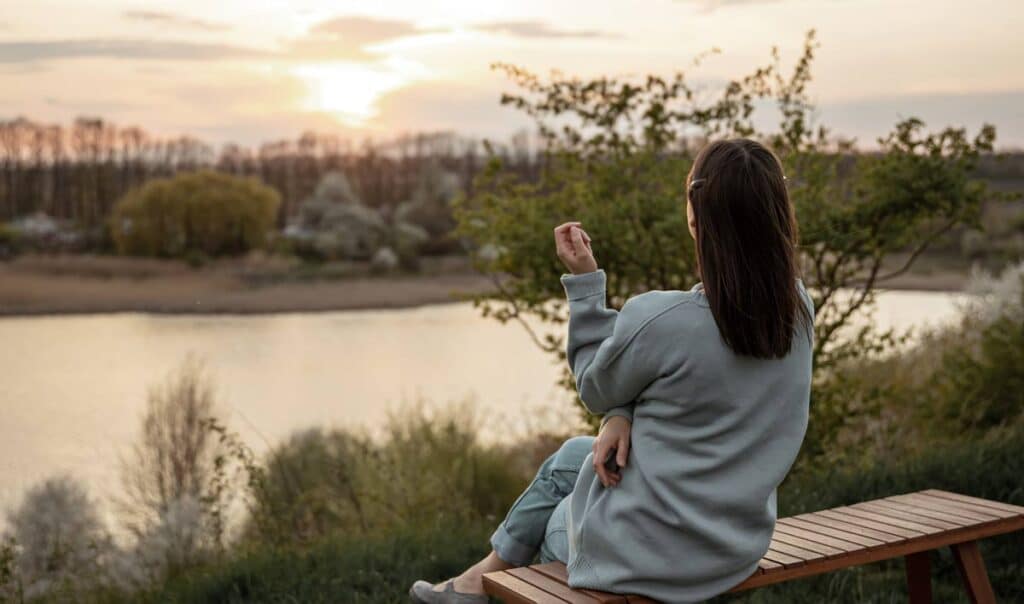 caregiver self-care woman sitting outdoors and relaxing