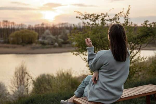 caregiver self-care woman sitting outdoors and relaxing