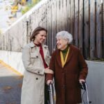 granddaughter helping grandmother walk