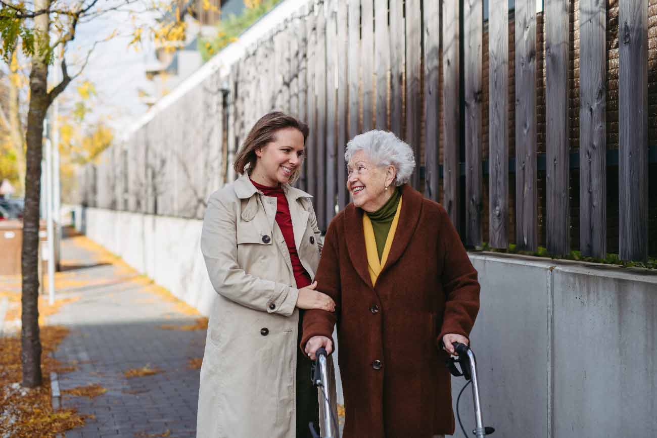 granddaughter helping grandmother walk