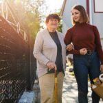 family caregiver helping elderly mother get groceries