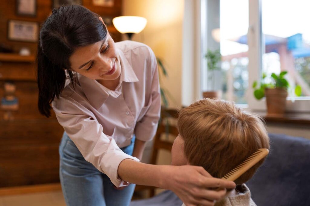 female caregiver grooming task elderly woman