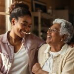 elderly woman with caregiver daughter smiling