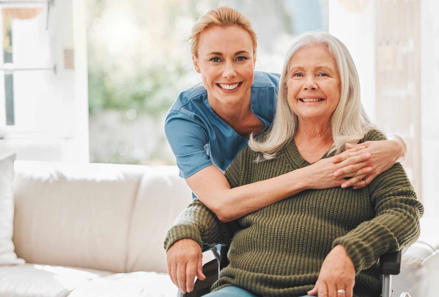 caregiver hugging patient in wheelchair