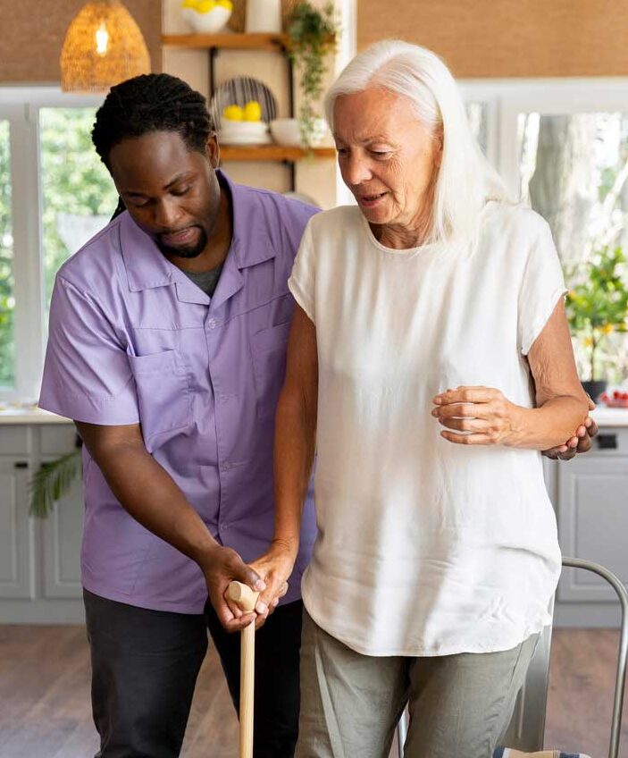 caregiver helping patient walk