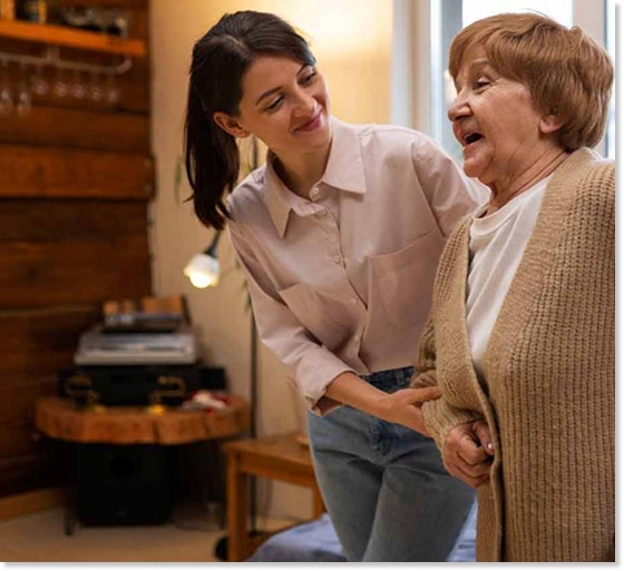 family caregiver helping elderly woman walk