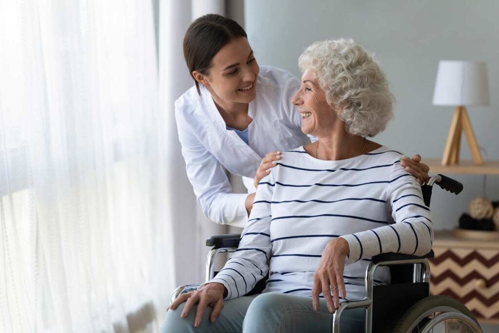caregiver holding patient in wheelchair