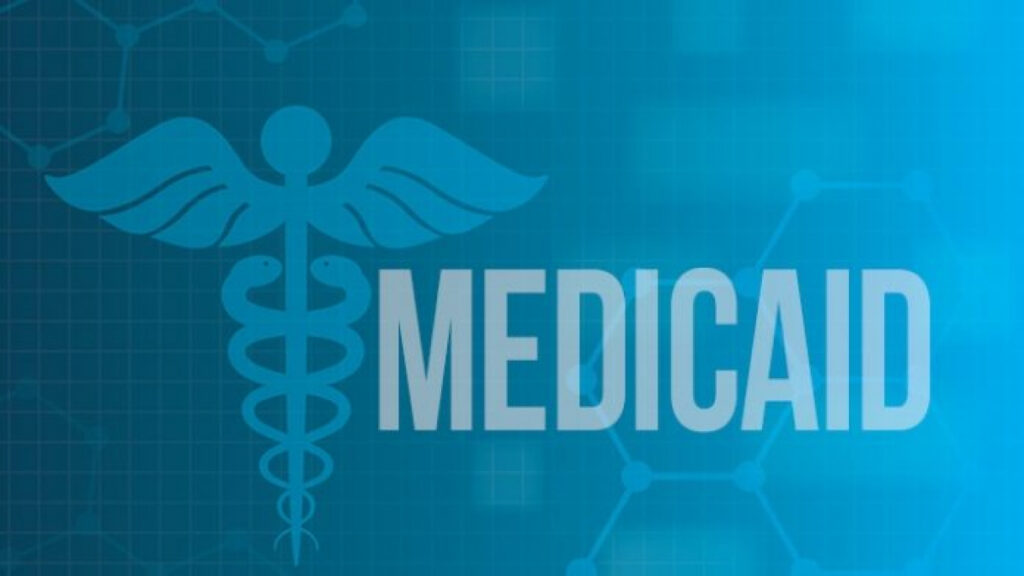 The image features a blue background with a caduceus medical symbol and the word MEDICAID in bold white letters. The background includes subtle grid lines and molecule structures.