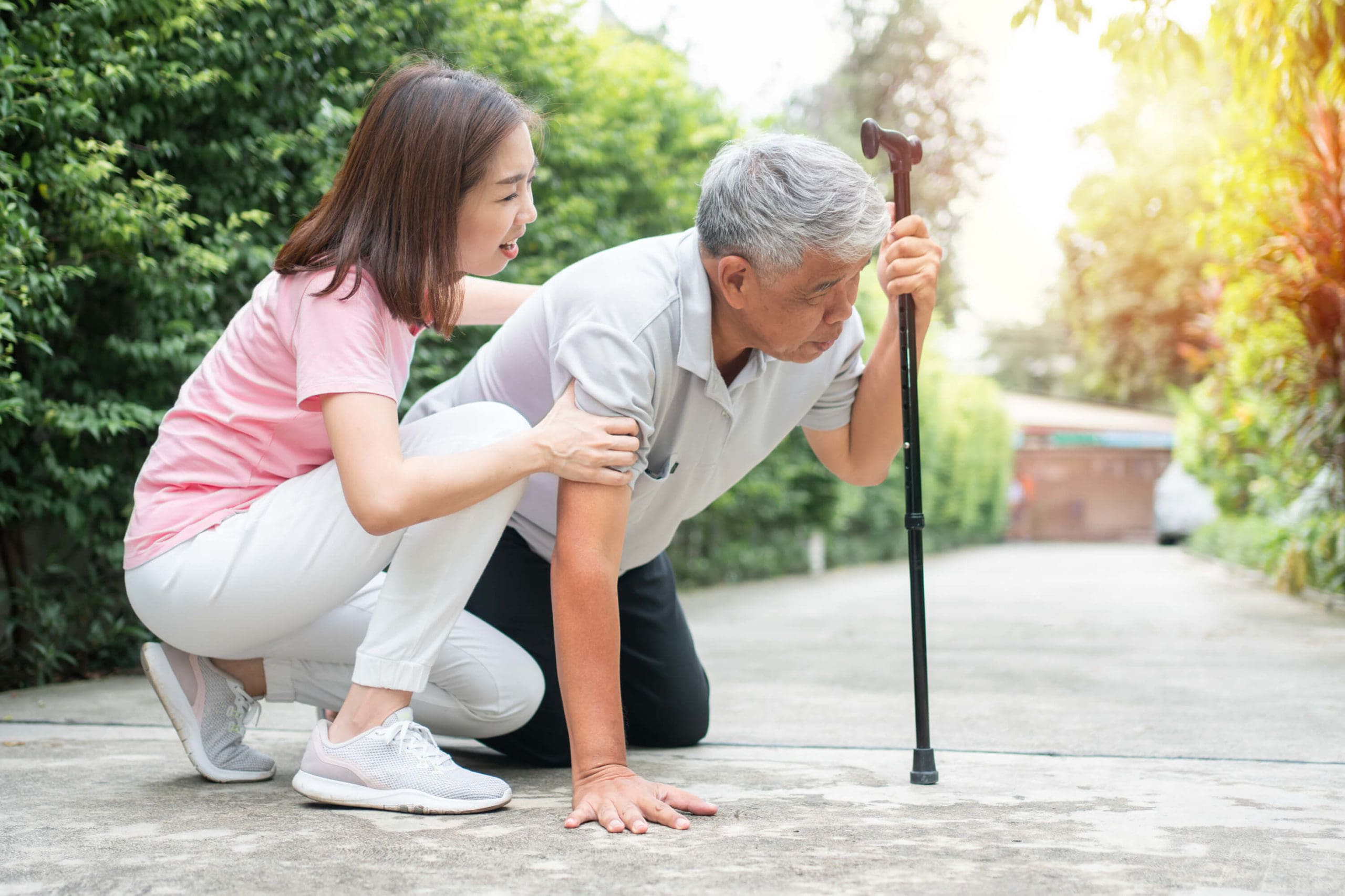 fallen elderly man being helped up