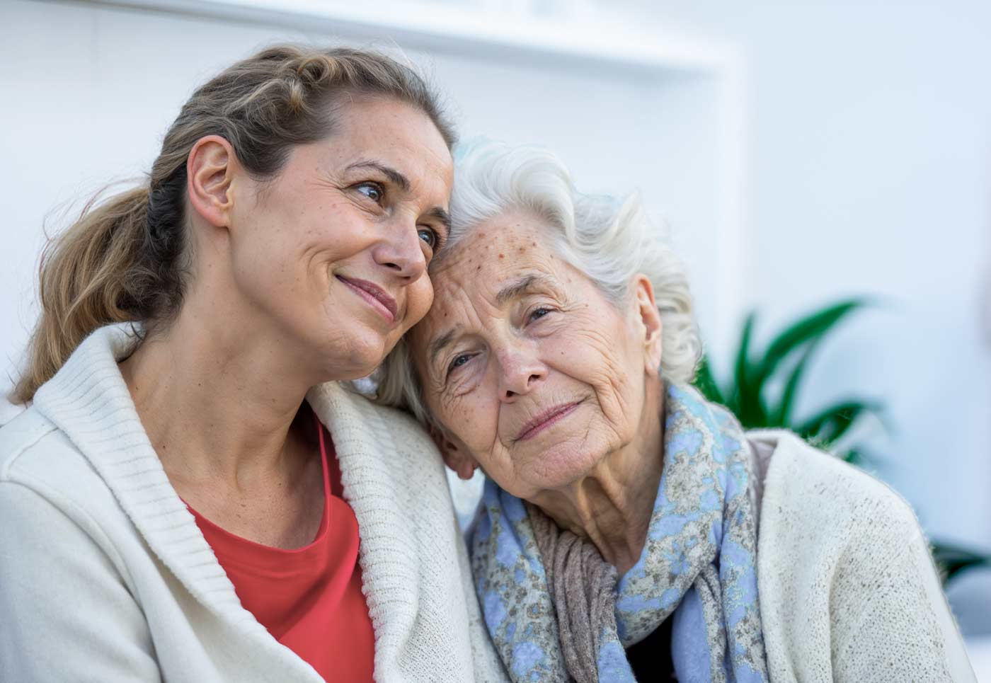 caregiver daughter holding closely elderly mother