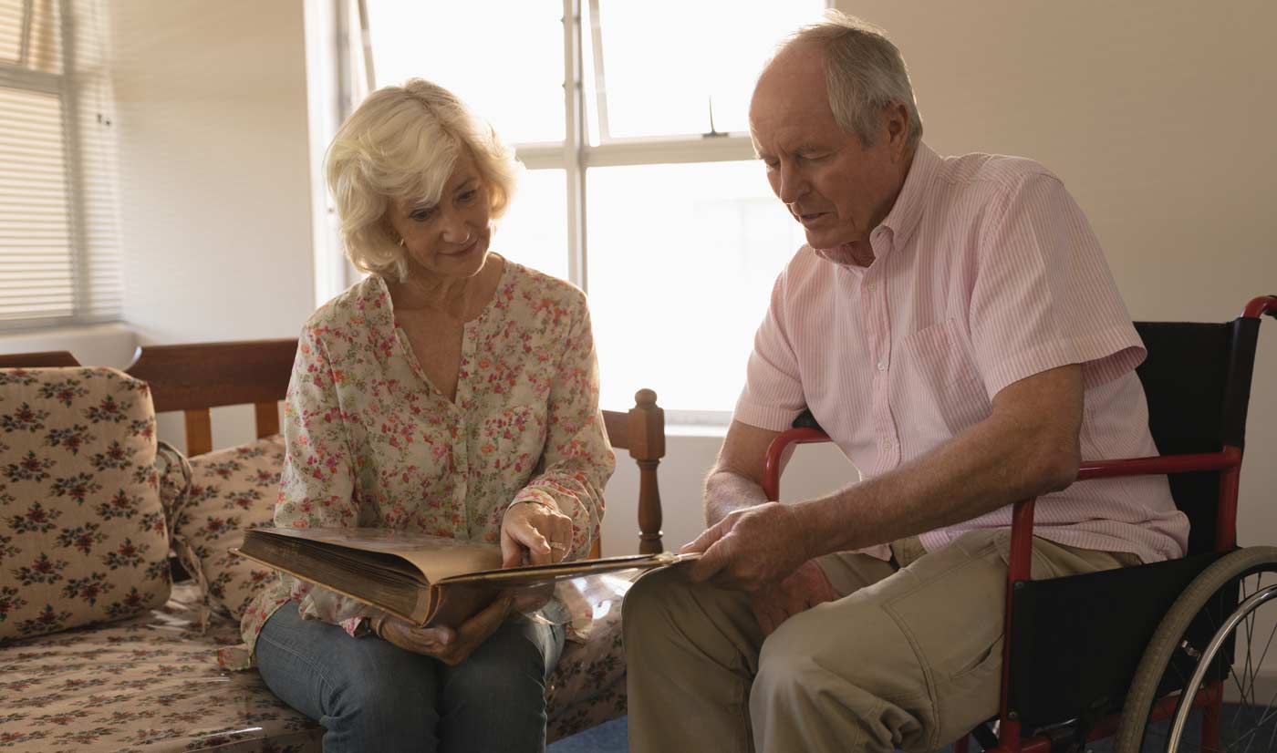 caregiver spouse helping disabled husband