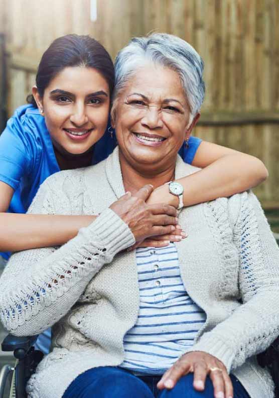 Caregiver helping an elderly patient in a wheelchair
