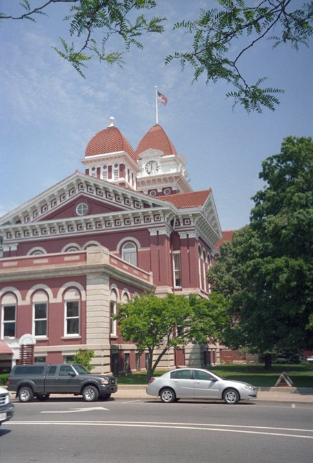 Historic Lake County Courthouse, known as the Grand Old Lady, on Courthouse Square in Crown Point, Indiana, with red brick walls, limestone trim, and a central clock tower.